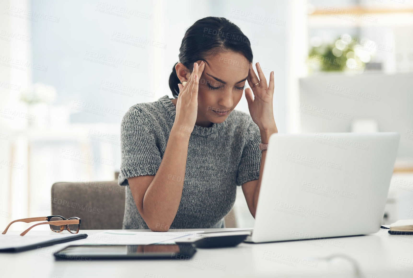 Buy stock photo Headache, tired and stressed young businesswoman with financial problems on laptop sitting at desk. Professional female accountant in accounting finance and corporate business doing taxes and debt.