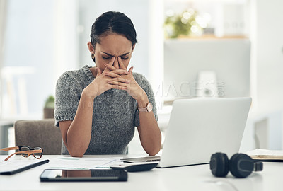 Buy stock photo Stress, anxiety and worry with a businesswoman feeling negative, overworked and overwhelmed while suffering from a headache or migraine. Young female working on a laptop at her desk in the office