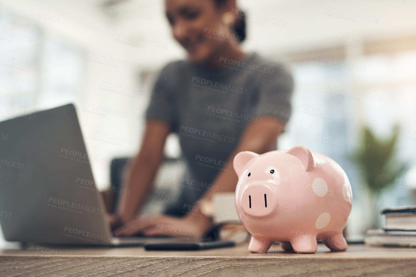 Buy stock photo Finance, banking and saving money with piggybank, investing and planning while working on a laptop in an office at work. Managing and growth of budget for insurance, investment and retirement