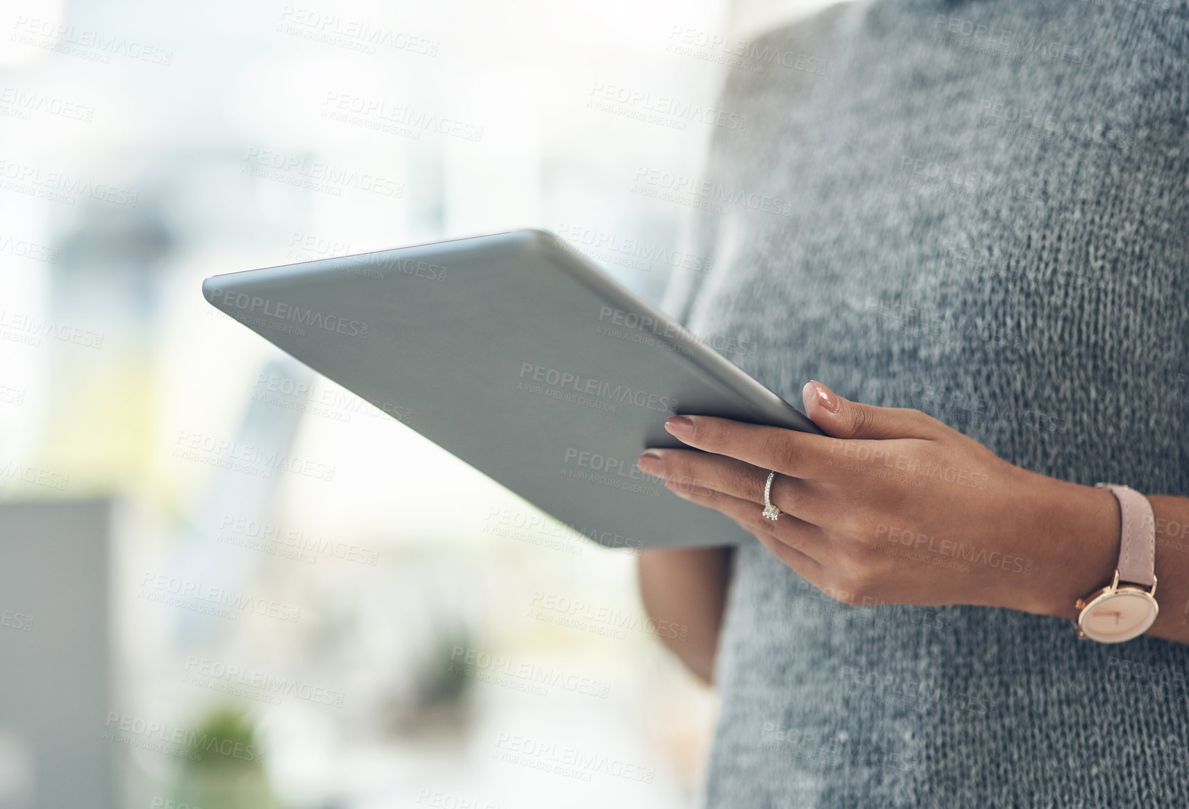 Buy stock photo Closeup shot of an unrecognisable businesswoman using a digital tablet in an office