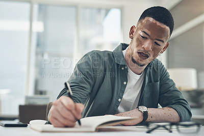 Buy stock photo Shot of a young business man working in a modern office