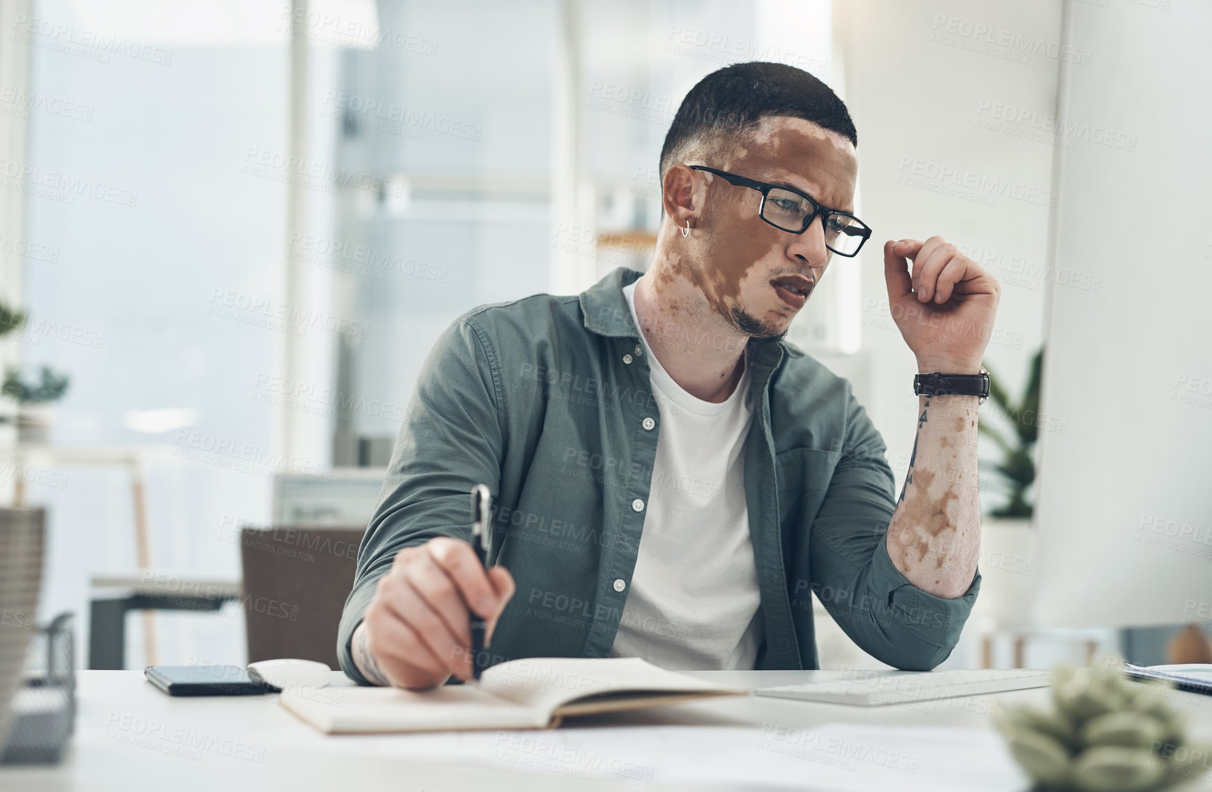 Buy stock photo Shot of a young business man working in a modern office