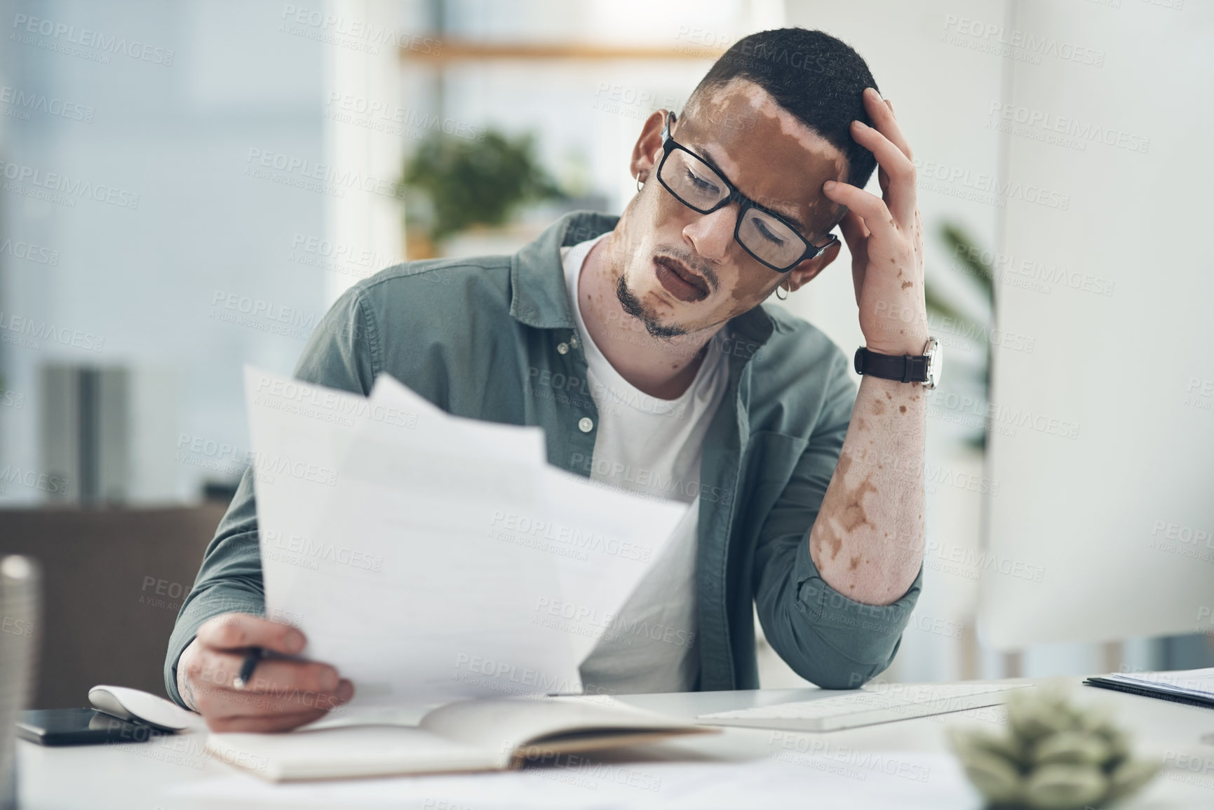 Buy stock photo Shot of a young business man working in a modern office