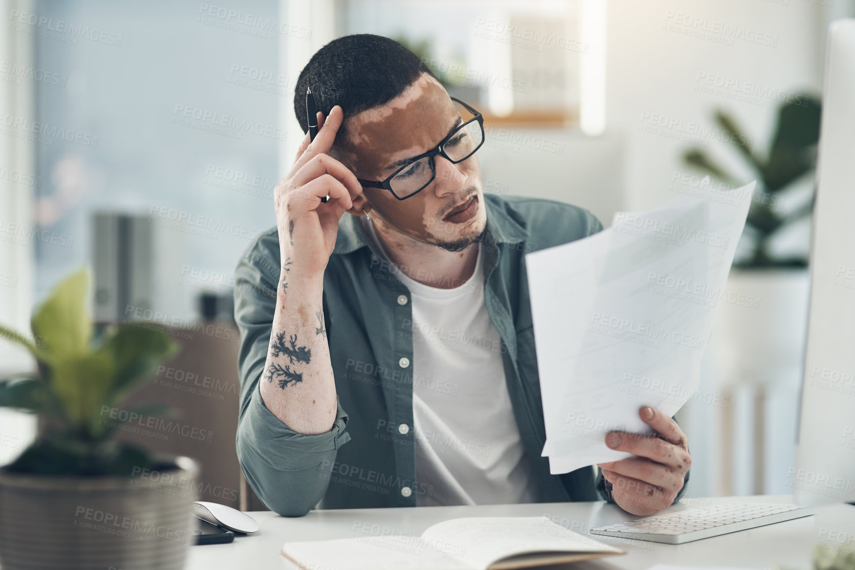 Buy stock photo Shot of a young business man working in a modern office