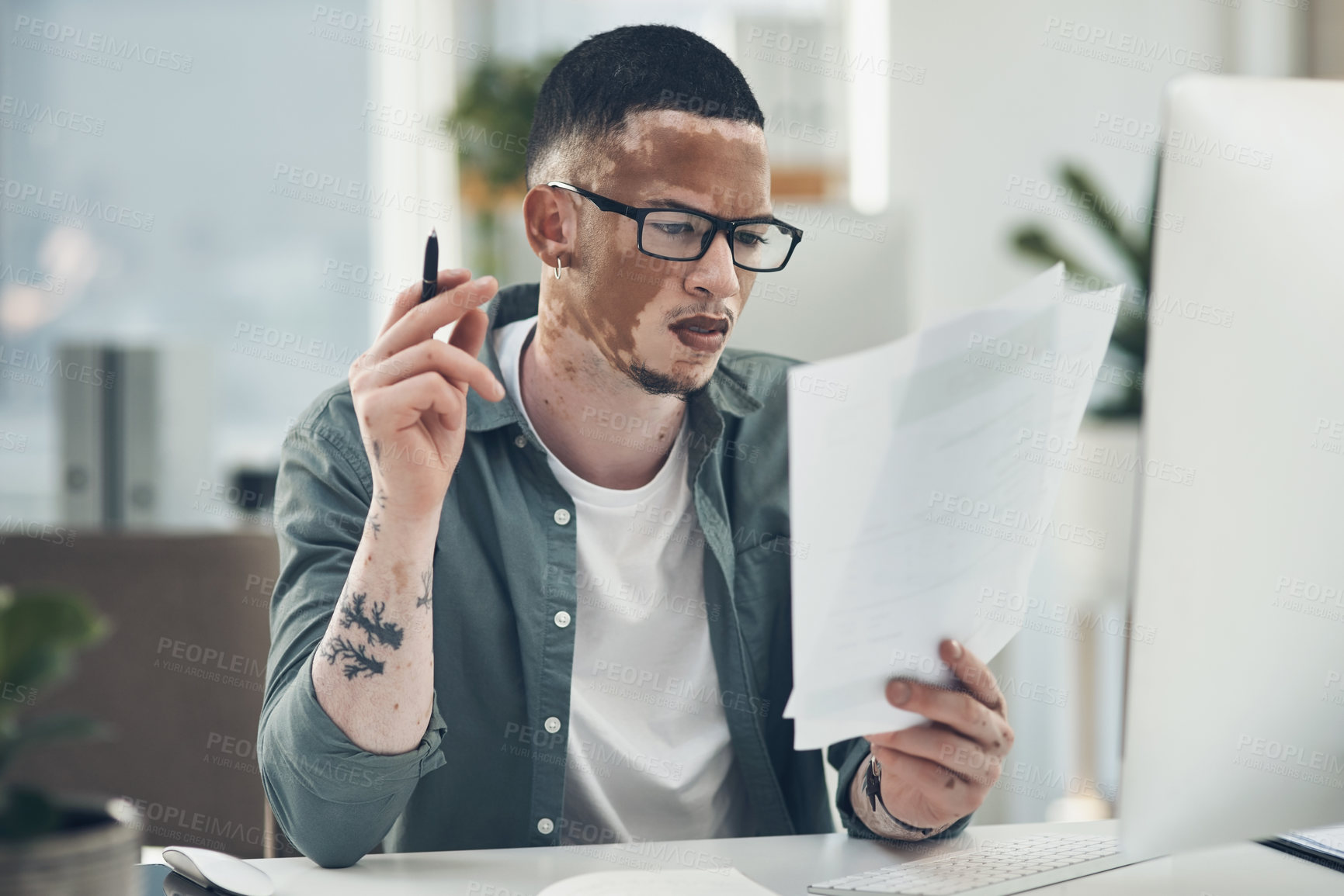 Buy stock photo Shot of a young business man working in a modern office