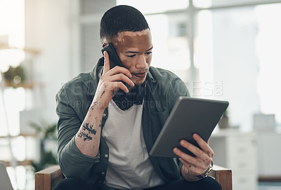 Buy stock photo Shot of a young business man on a phone call in a modern office