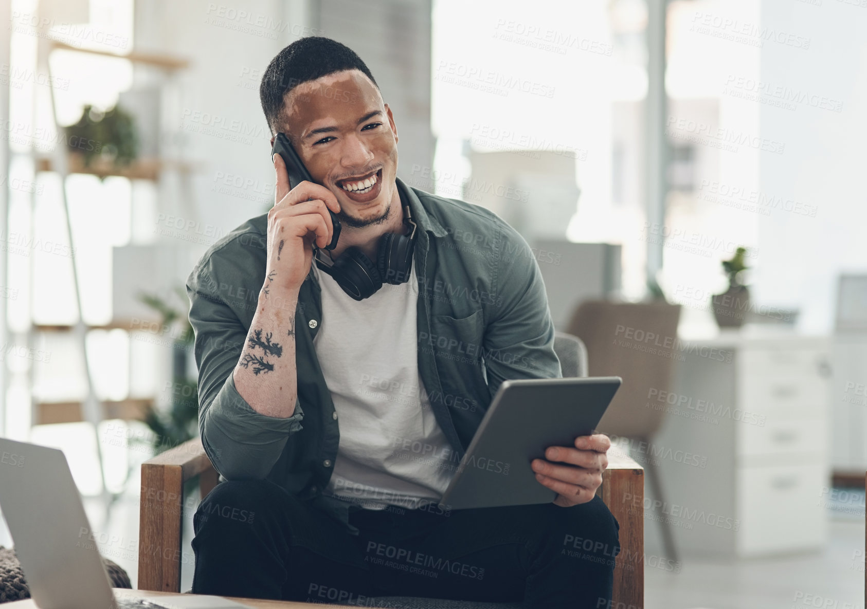 Buy stock photo Shot of a young business man on a phone call in a modern office