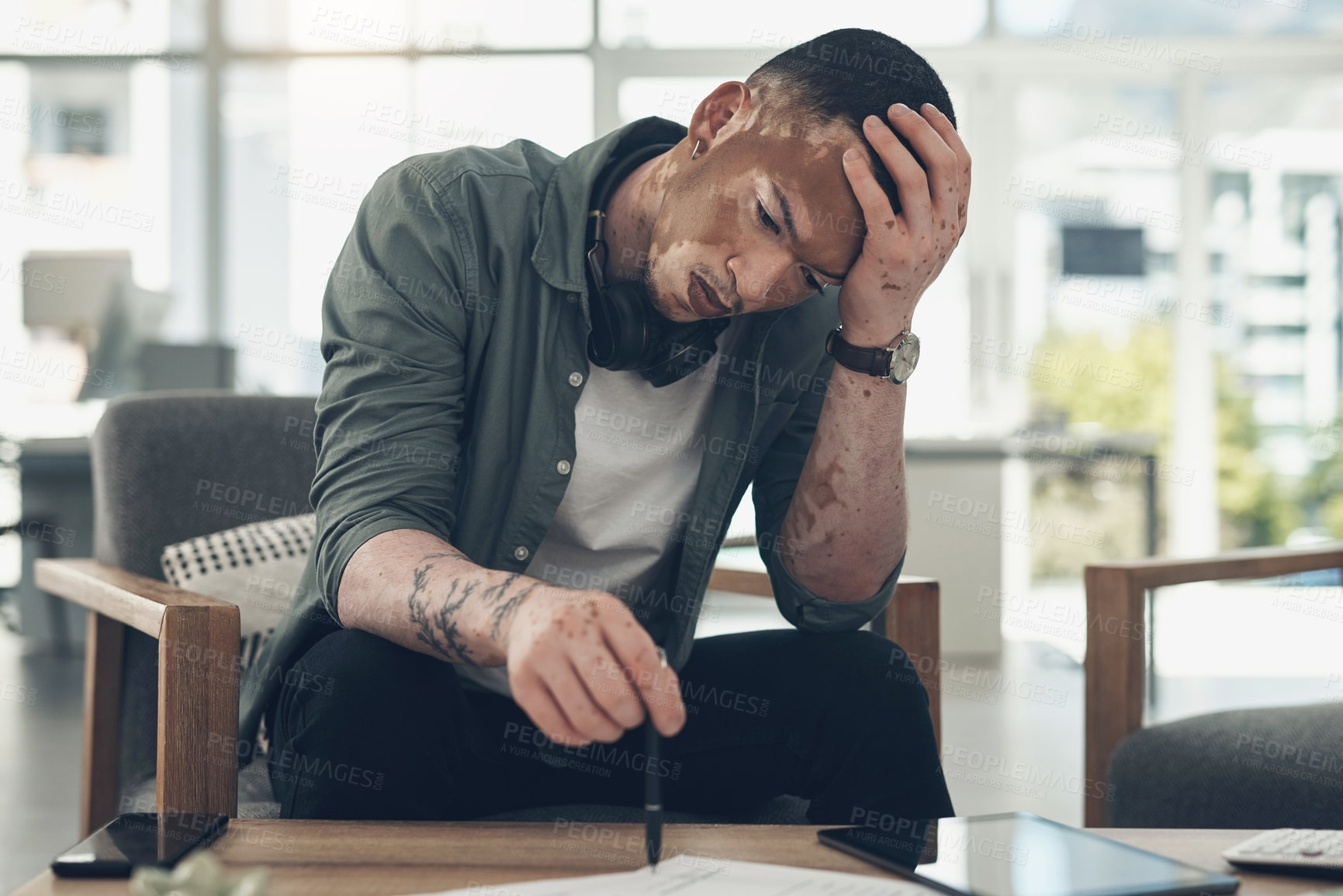 Buy stock photo Shot of a young business man having a stressful day at work