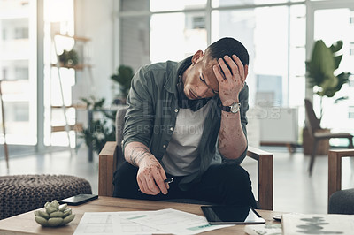 Buy stock photo Shot of a young business man having a stressful day at work