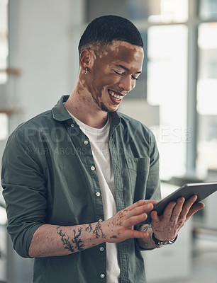 Buy stock photo Shot of a young business man using a tablet at work