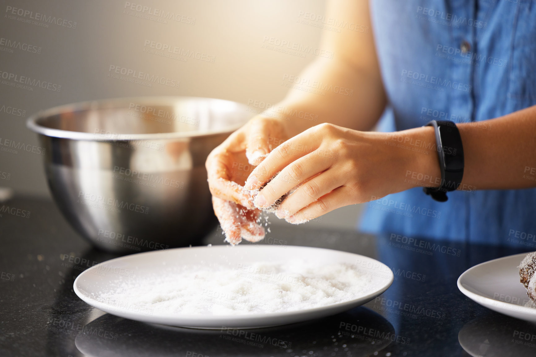 Buy stock photo Coconut balls, hands and plate in kitchen, table and baking and person in India, festival and treats. House, chef and sweets for dessert in celebration, powder and sugar for startup or small business