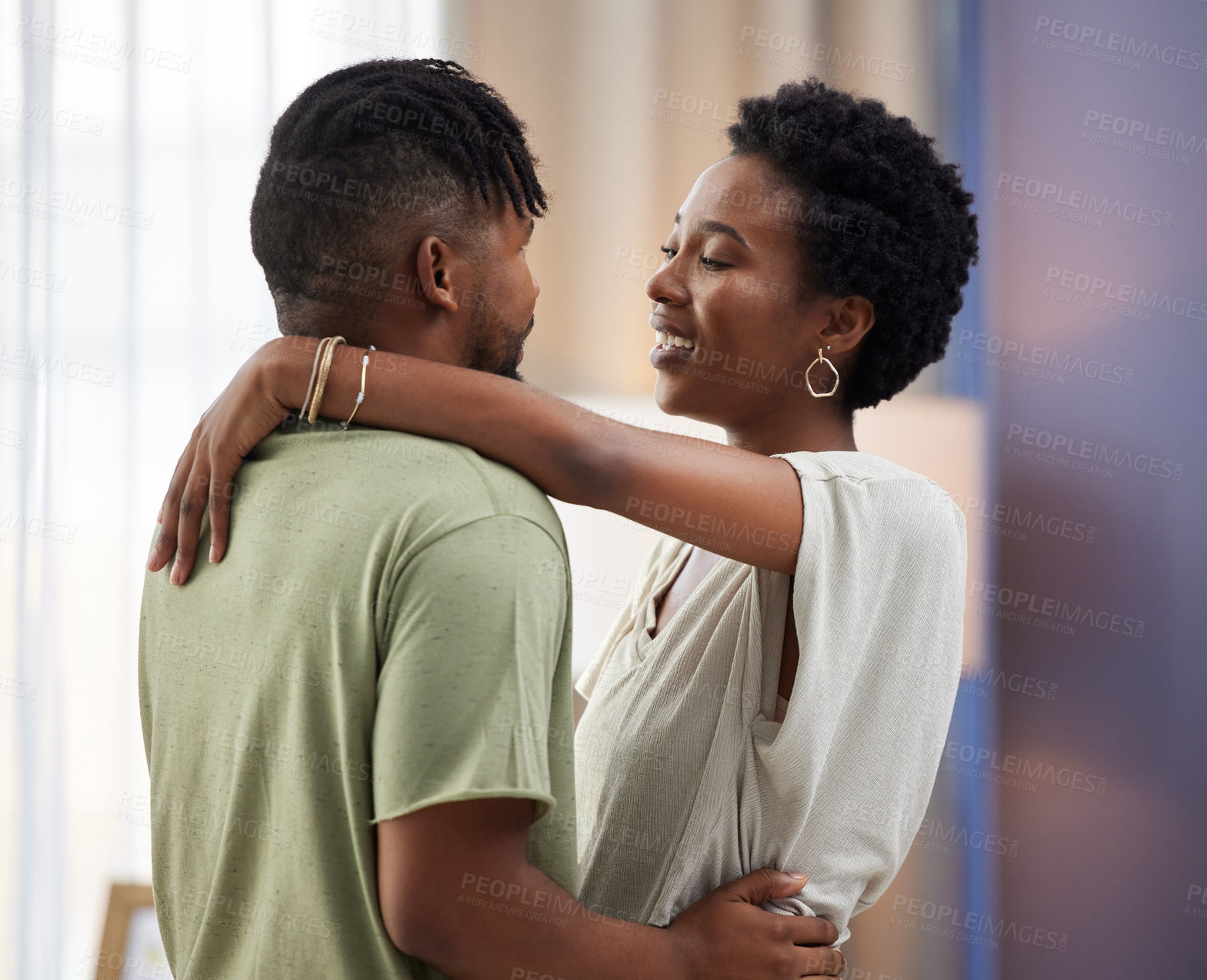 Buy stock photo Shot of a young couple dancing in the living room at home