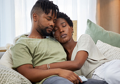 Buy stock photo Shot of a young couple taking a nap on the couch at home