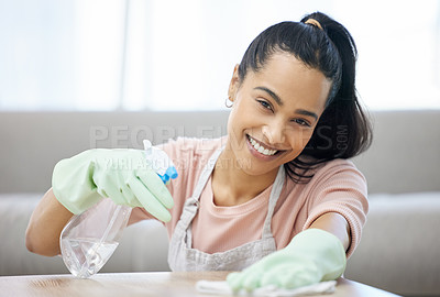 Buy stock photo Shot of a young woman cleaning a surface at home