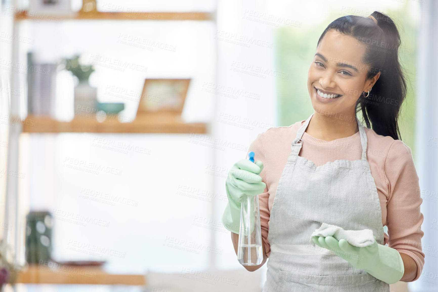 Buy stock photo Shot of a young woman doing chores at home