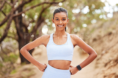 Buy stock photo Portrait, woman and runner with confidence in forest for running workout, fitness watch and strong body. Indian athlete, trees and exercise in woods with wearable tech, nature run and sports training