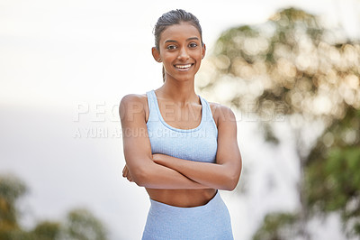 Buy stock photo Shot of a young woman getting ready for a jog outdoors