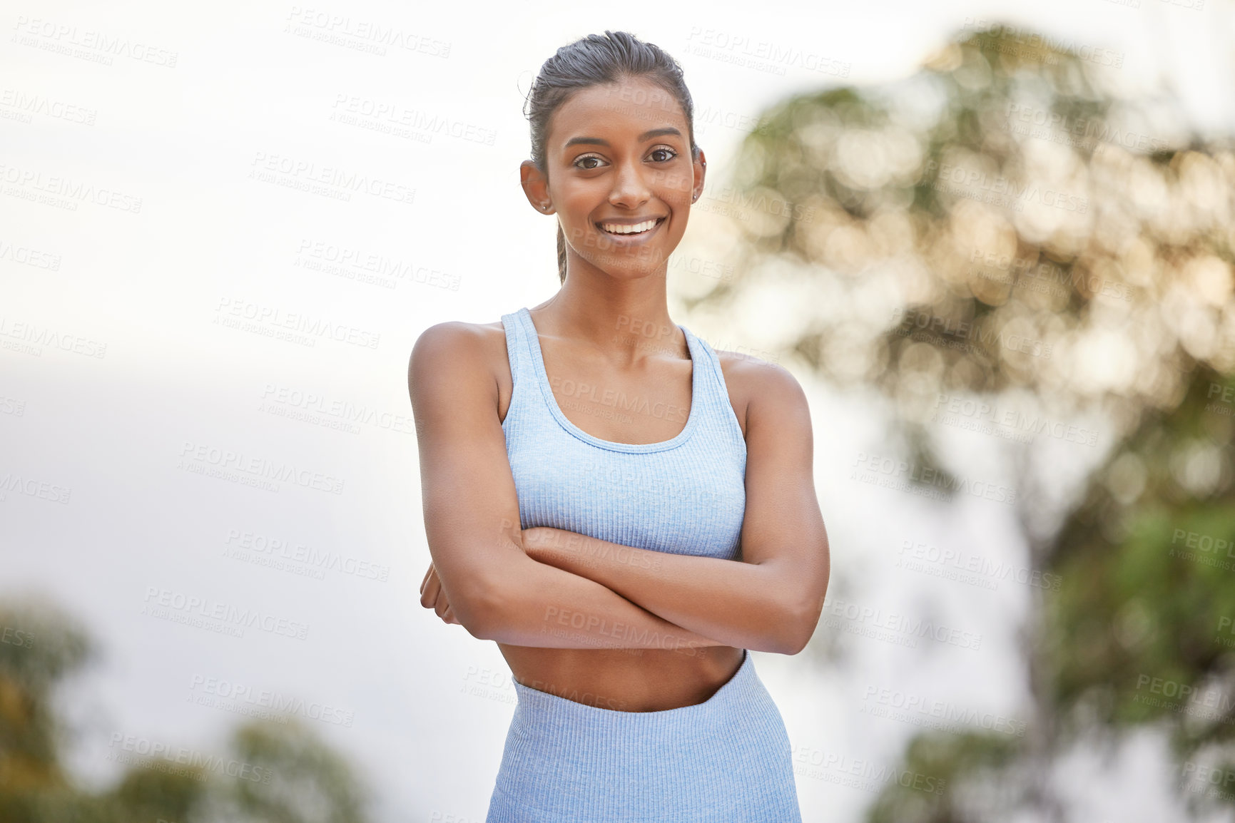 Buy stock photo Shot of a young woman getting ready for a jog outdoors