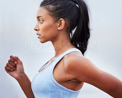 Buy stock photo Shot of a young woman jogging