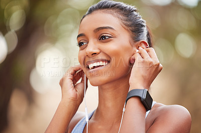 Buy stock photo Fitness, earphones and happy woman in park for running, training or morning cardio with music. Sports, smile and Indian runner in forest for exercise, workout and streaming podcast for run motivation