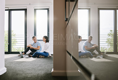 Buy stock photo Full length shot of a young couple sitting on the floor together in the new house and using a laptop