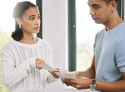 Buy stock photo Shot of a young couple standing together and planning the interior design of their new home