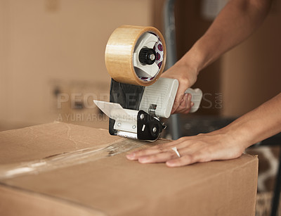 Buy stock photo Shot of a unrecognizable woman packing up to move in a room at home