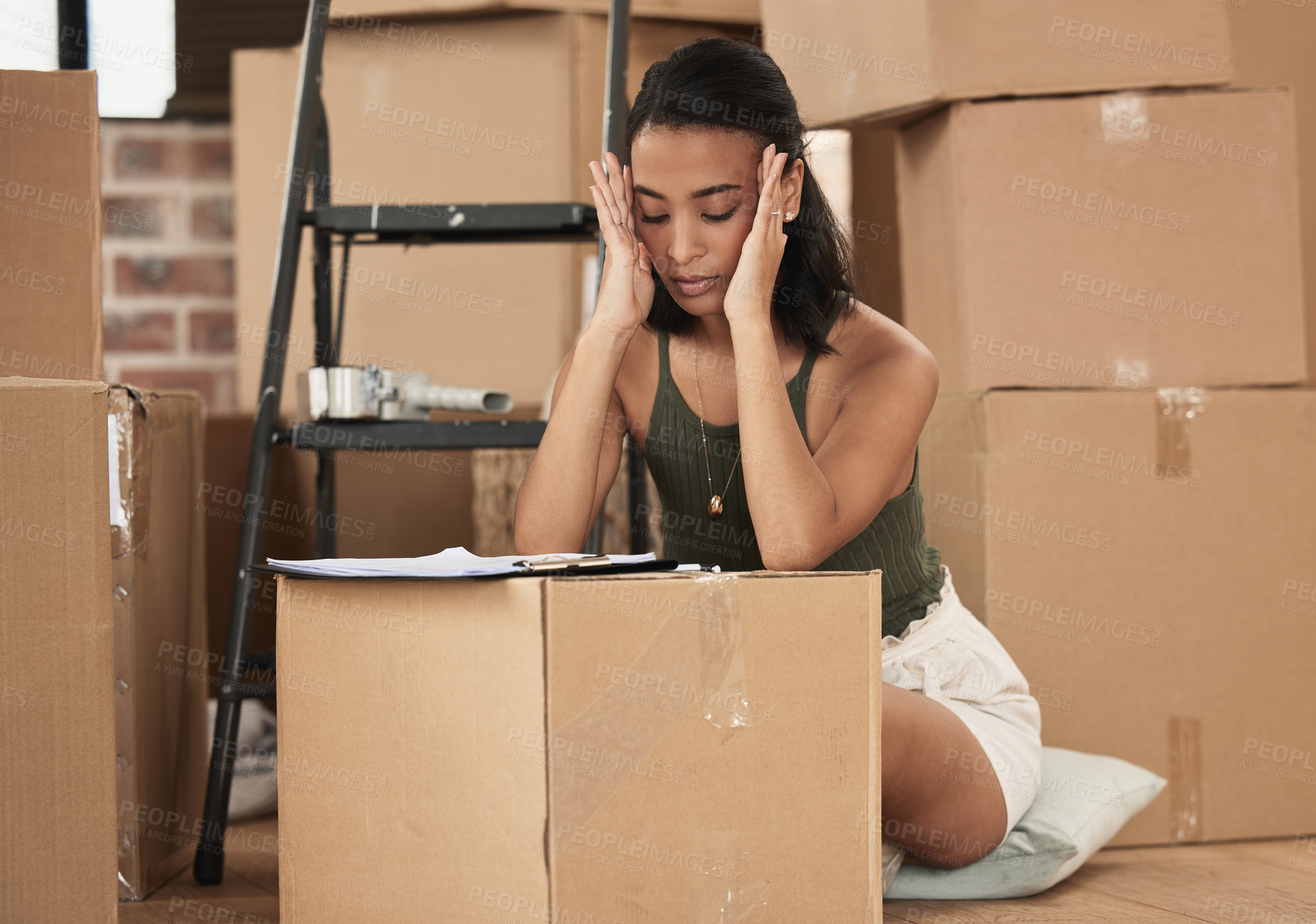 Buy stock photo Shot of a young woman having a stressful day during packing at home