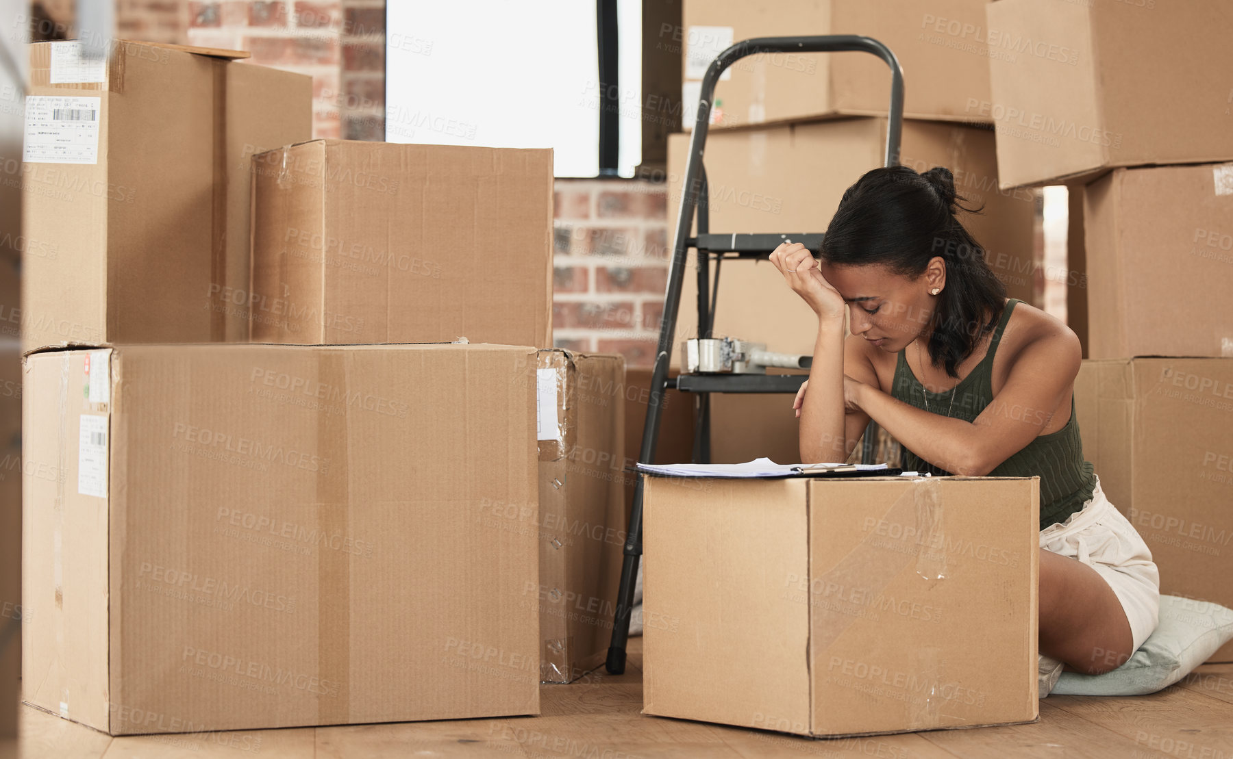 Buy stock photo Shot of a young woman having a stressful day during packing at home