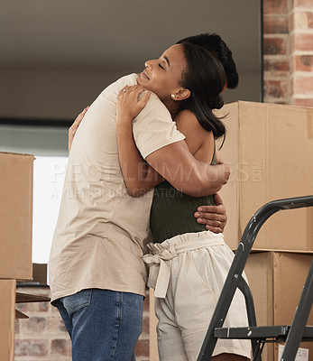 Buy stock photo Shot of a young couple hugging in to their new home