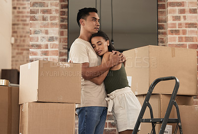 Buy stock photo Shot of a young couple hugging in to their new home