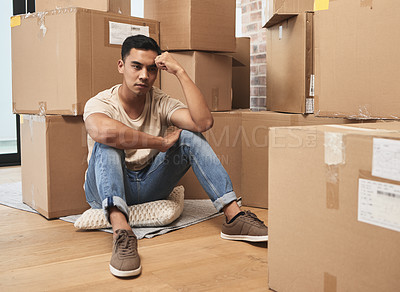 Buy stock photo Shot of a young man being upset while sitting on the floor at home