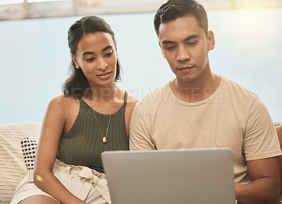 Buy stock photo Shot of a couple using a laptop at home