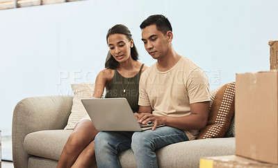 Buy stock photo Shot of a couple using a laptop at home