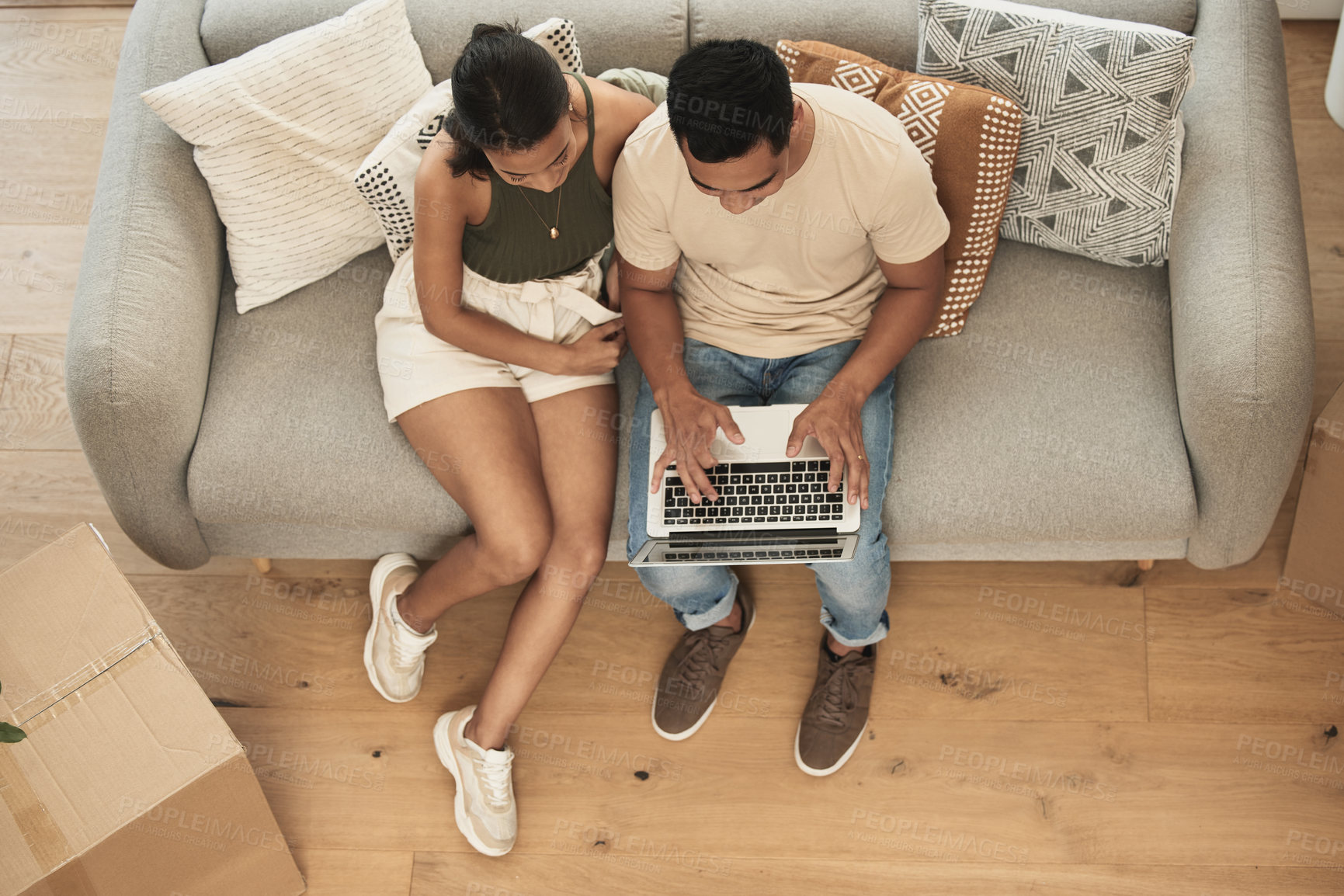 Buy stock photo Shot of a couple using a laptop at home