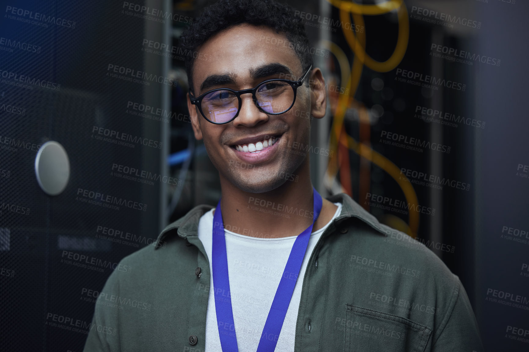 Buy stock photo Cropped portrait of a handsome male IT support agent working in a dark network server room