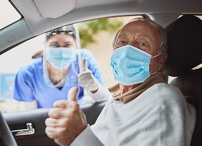 Buy stock photo Shot of a senior man and a young healthcare worker showing a thumbs up at a drive through vaccination site