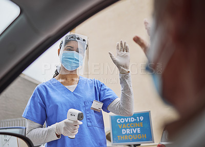 Buy stock photo Shot of a young healthcare worker waving to a patient in their car at a drive through vaccination site
