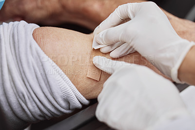 Buy stock photo Shot of an unrecognizable healthcare worker applying a band-aid to a patient's arm at a drive through vaccination site