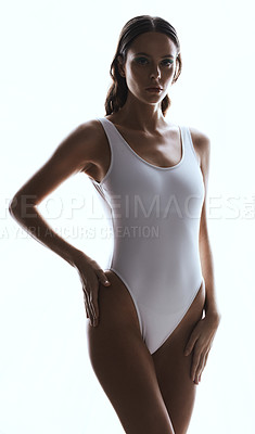 Buy stock photo Studio shot of a beautiful woman in a swimsuit against a white background