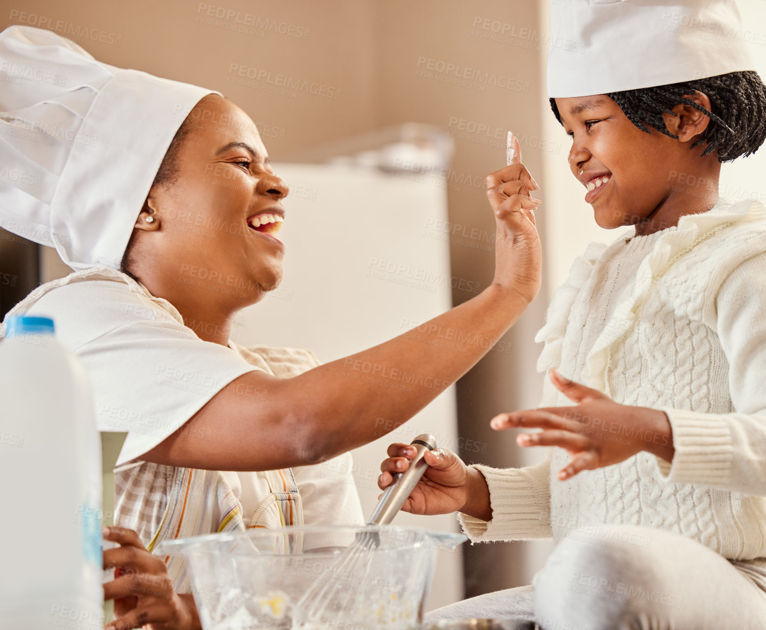 Buy stock photo Baking, playing and black woman in kitchen with child mixing ingredients, fun and help in home. Family, cooking and mother teaching girl to bake for development, learning or bonding together