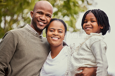 Buy stock photo Portrait shot of a young family spending time in nature