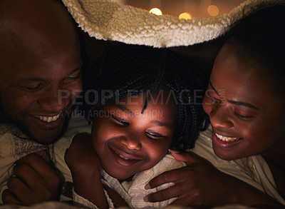 Buy stock photo Shot of a young family bonding at home