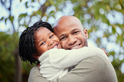 Buy stock photo Shot of a young father and daughter hugging in nature