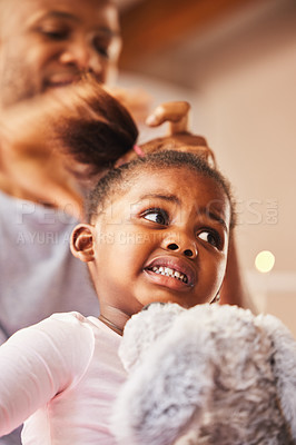 Buy stock photo Shot of a young father doing his daughter's hair at home