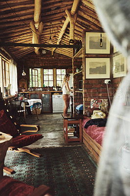 Buy stock photo Shot of a young woman busy in a cabin