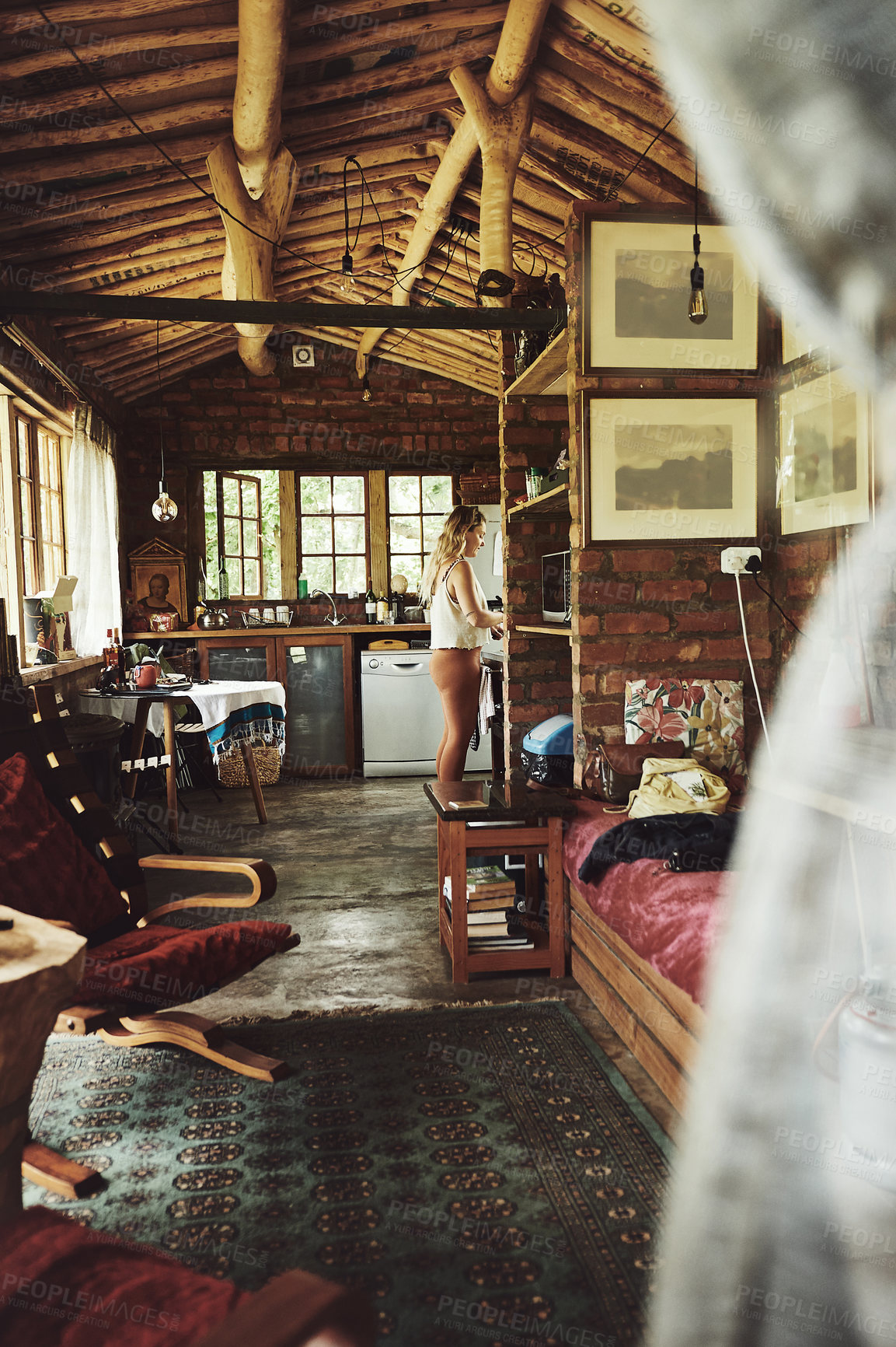 Buy stock photo Shot of a young woman busy in a cabin