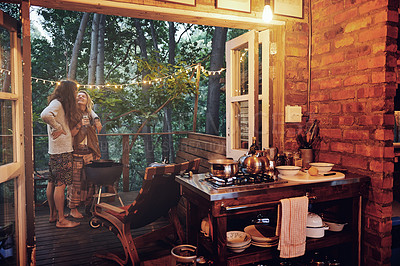 Buy stock photo Shot of a young couple preparing dinner while on vacation in a cabin