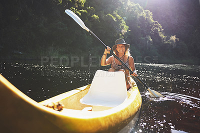 Buy stock photo Shot of a young woman out kayaking on a lake