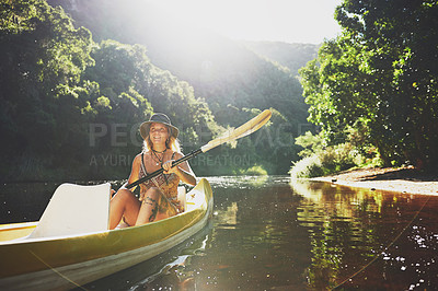 Buy stock photo Shot of a young woman out kayaking on a lake